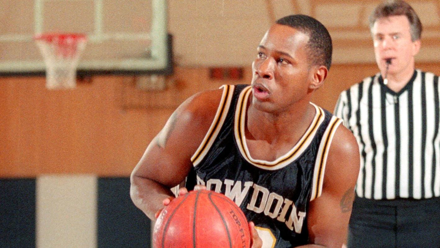 A man holding onto a basketball in his hand.